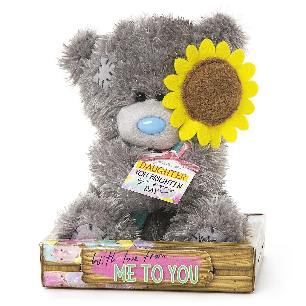 teddy bear holding a sunflower